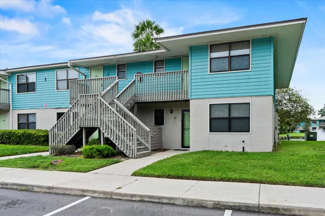 a front view of a house with a garden and plants