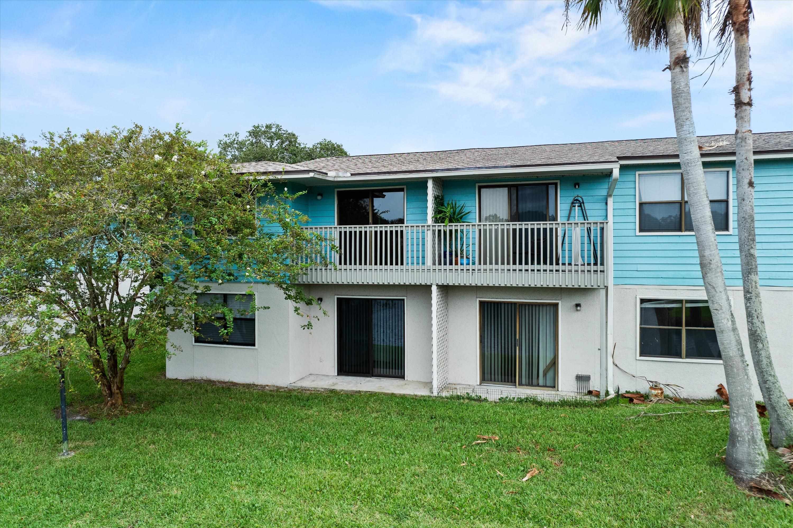 650 West Pope Road, Unit 208 St. Augustine, FL 32080 - Photo 25 of 35 a front view of a house with a garden