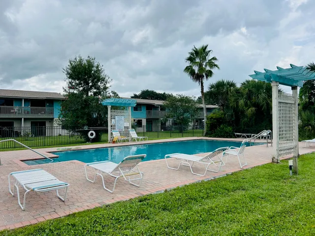 a view of a house with a swimming pool and a yard
