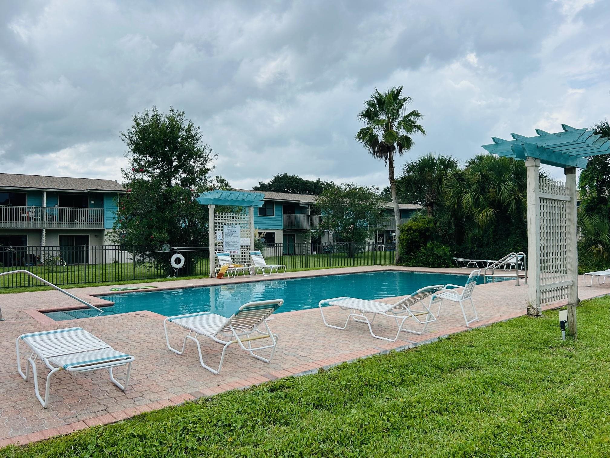 650 West Pope Road, Unit 208 St. Augustine, FL 32080 - Photo 28 of 35 a view of a house with a swimming pool and a yard