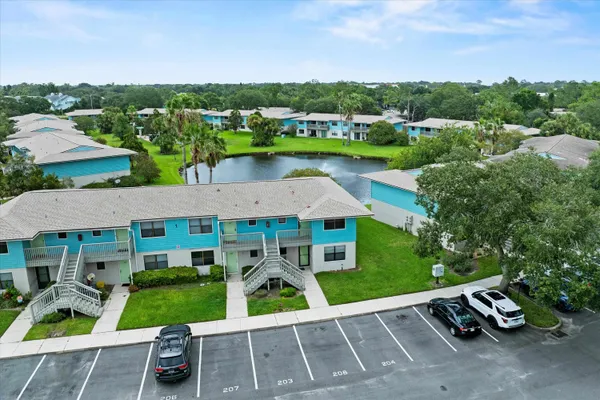 an aerial view of a house with pool table and chairs