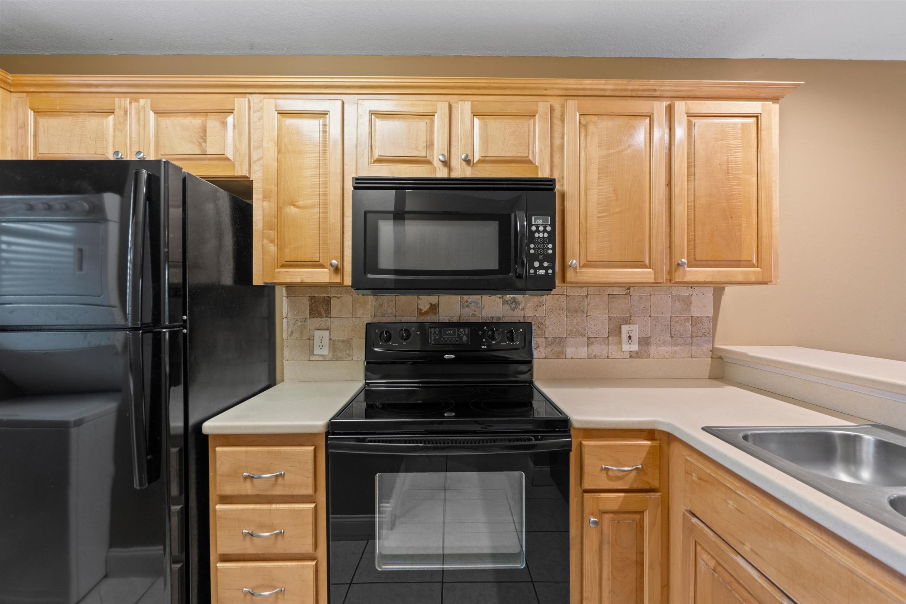 650 West Pope Road, Unit 208 St. Augustine, FL 32080 - Photo 10 of 35 a kitchen with granite countertop a stove and a refrigerator