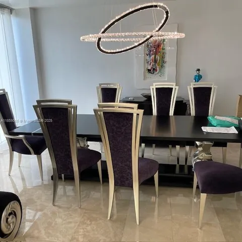 a view of a dining room with furniture and a chandelier