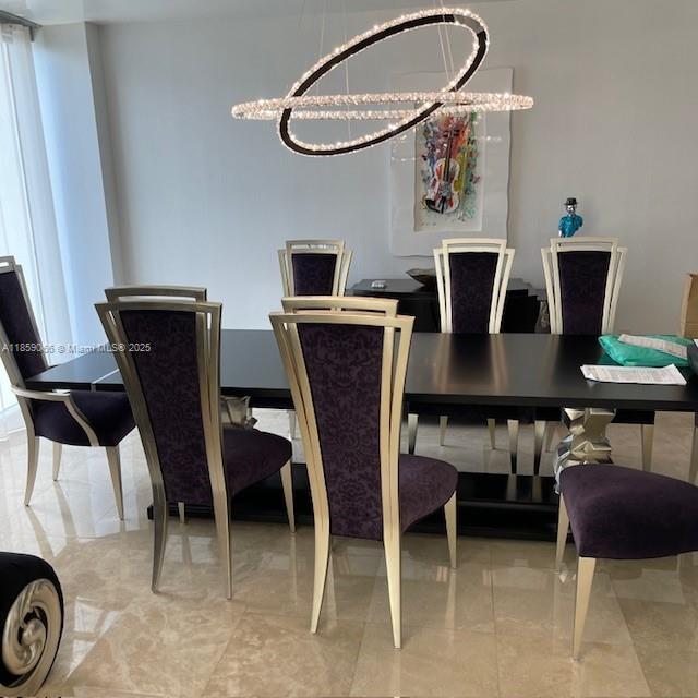 20201 East Country Club Drive, Unit 704 Aventura, FL 33180 - Photo 12 of 46 a view of a dining room with furniture and a chandelier