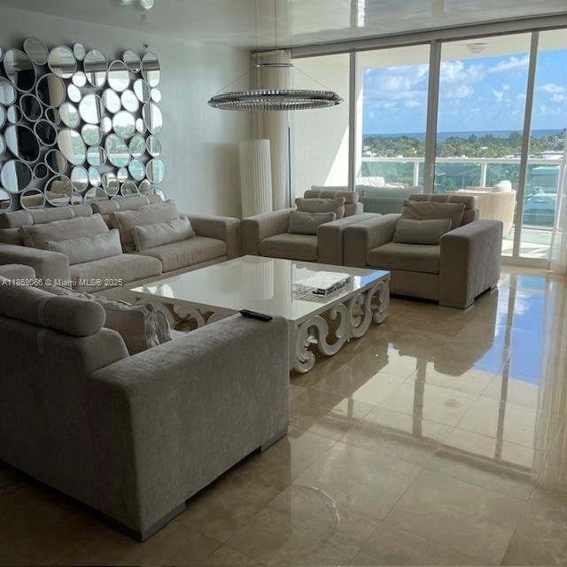 20201 East Country Club Drive, Unit 704 Aventura, FL 33180 - Photo 16 of 46 a living room with furniture and a large window