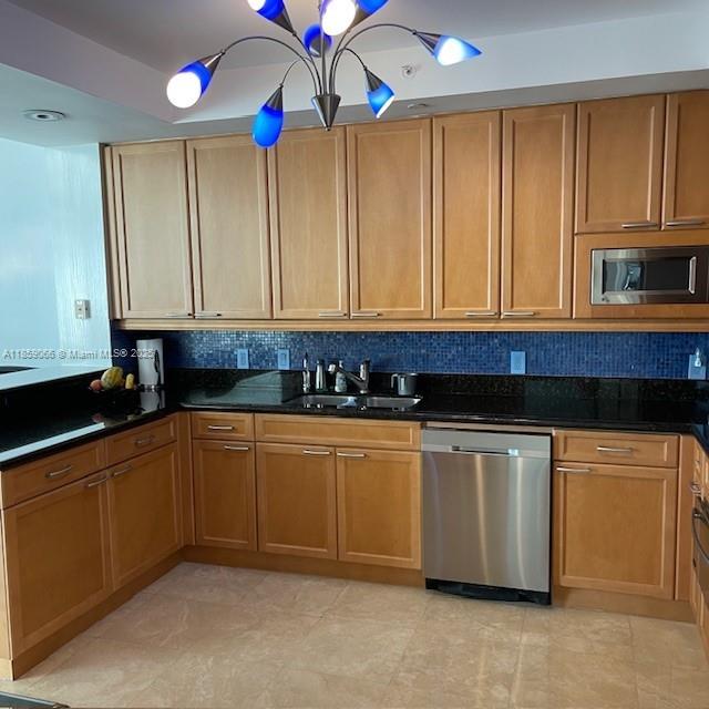 20201 East Country Club Drive, Unit 704 Aventura, FL 33180 - Photo 19 of 46 a kitchen with stainless steel appliances granite countertop wooden cabinets a sink and dishwasher