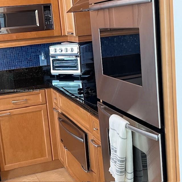 20201 East Country Club Drive, Unit 704 Aventura, FL 33180 - Photo 22 of 46 a kitchen with granite countertop stainless steel appliances a stove microwave and door