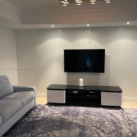 a living room with a flat screen tv and a couch