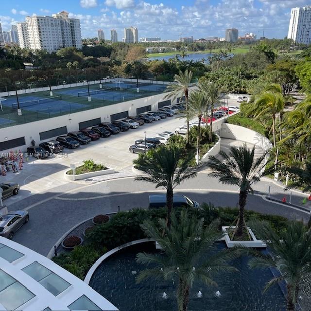 20201 East Country Club Drive, Unit 704 Aventura, FL 33180 - Photo 4 of 46 a view of a house with a yard and lake