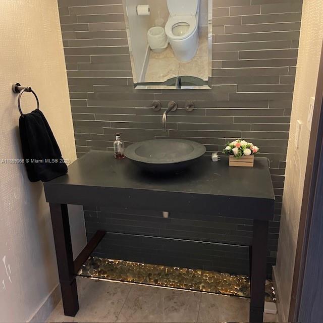 20201 East Country Club Drive, Unit 704 Aventura, FL 33180 - Photo 42 of 46 a bathroom with a sink a toilet and mirror