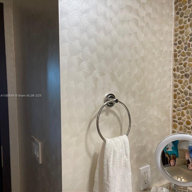 20201 East Country Club Drive, Unit 704 Aventura, FL 33180 - Photo 45 of 46 a bathroom with a granite countertop sink and a mirror