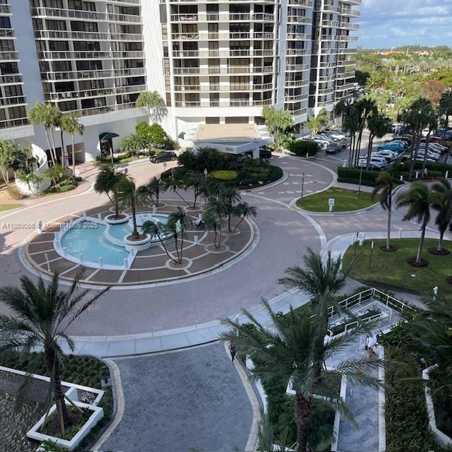 20201 East Country Club Drive, Unit 704 Aventura, FL 33180 - Photo 5 of 46 a view of a house with backyard sitting area and garden