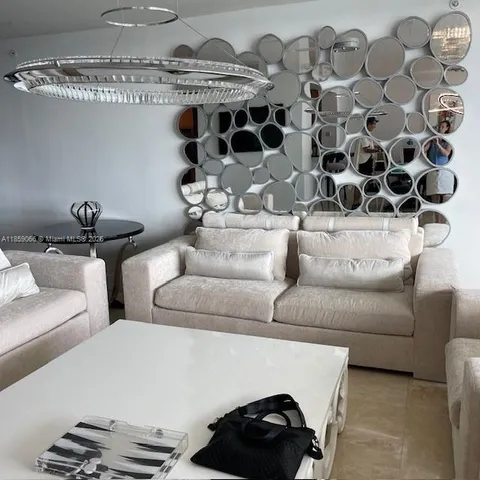 a living room with furniture and a black white checkered floor