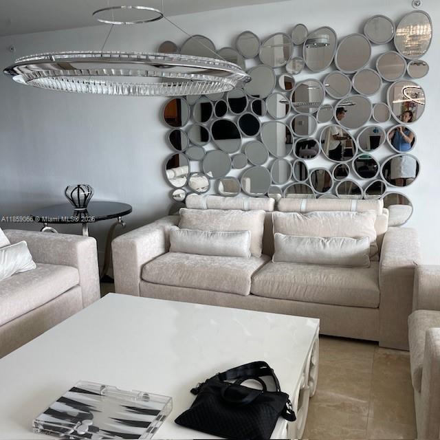 20201 East Country Club Drive, Unit 704 Aventura, FL 33180 - Photo 6 of 46 a living room with furniture and a black white checkered floor