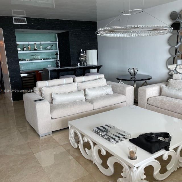 20201 East Country Club Drive, Unit 704 Aventura, FL 33180 - Photo 7 of 46 a living room with furniture and a flat screen tv