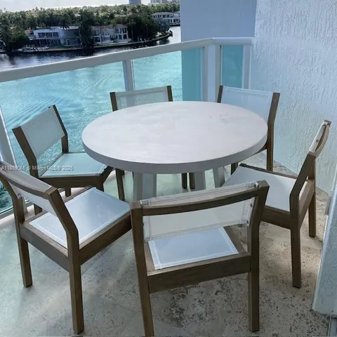 a view of a patio with table and chairs