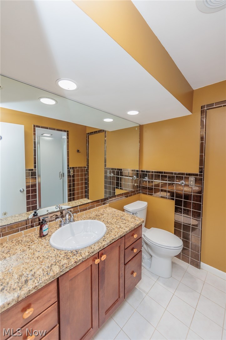 2444 Dysart Road Cleveland, OH 44118 - Photo 31 of 44 Bathroom featuring backsplash, tile walls, tile floors, toilet, and large vanity