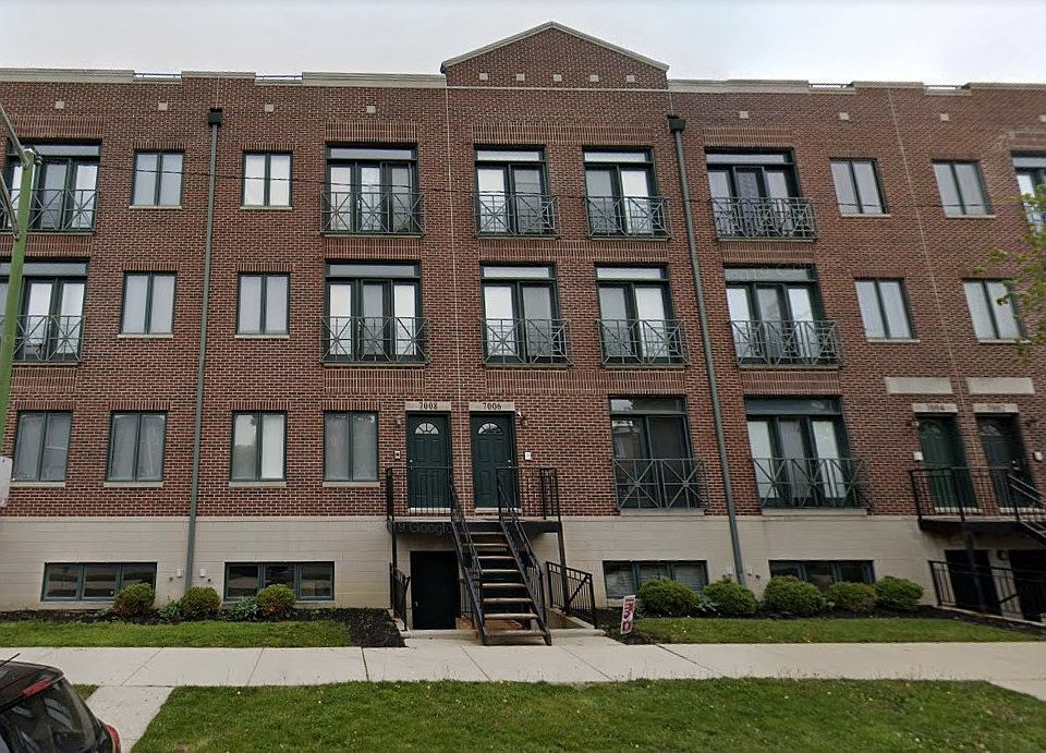 a front view of a residential apartment building with a yard