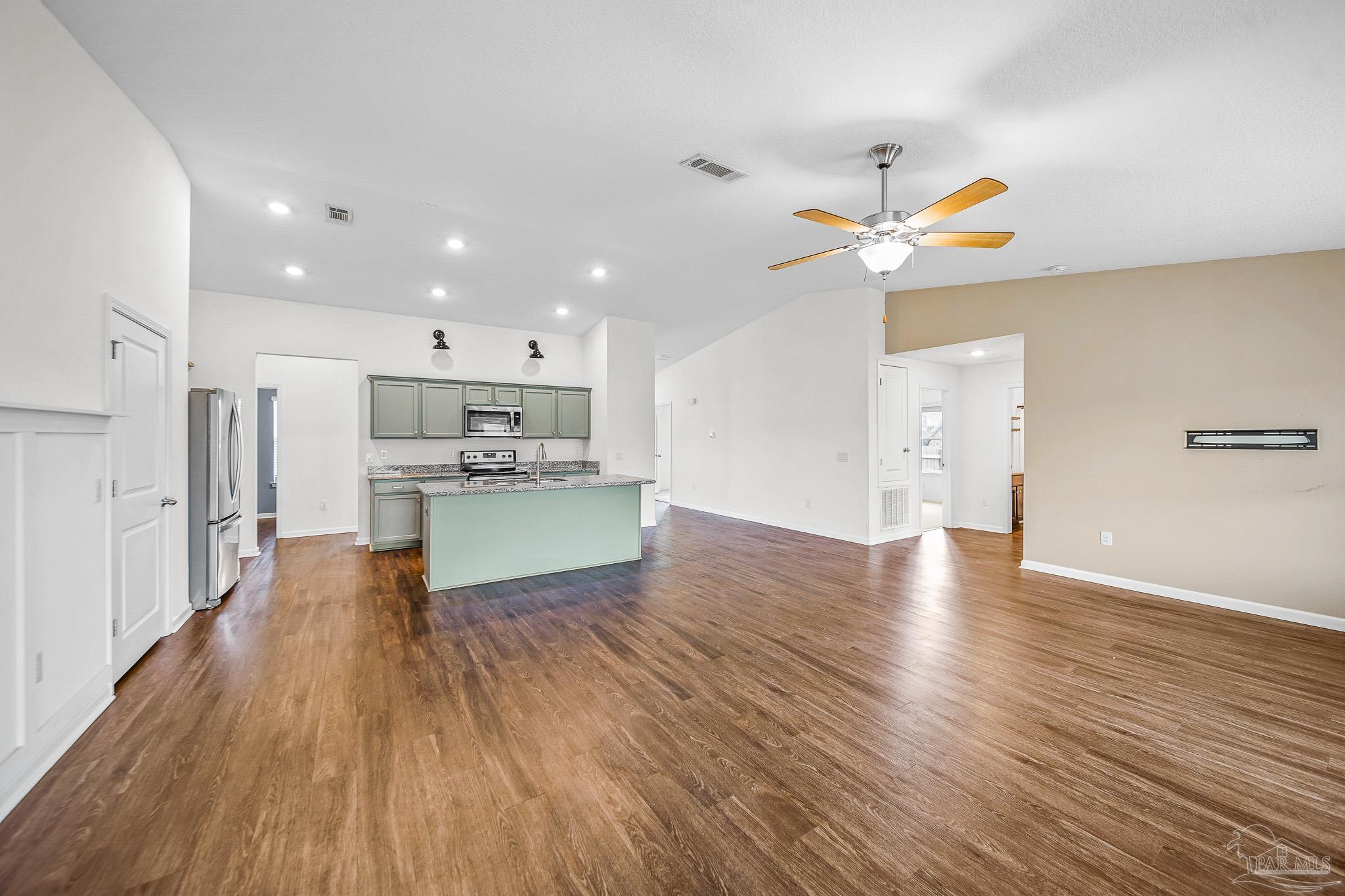 4706 Determination Court Milton, FL 32570 - Photo 11 of 34 a view of kitchen with a refrigerator wooden floor and a ceiling fan