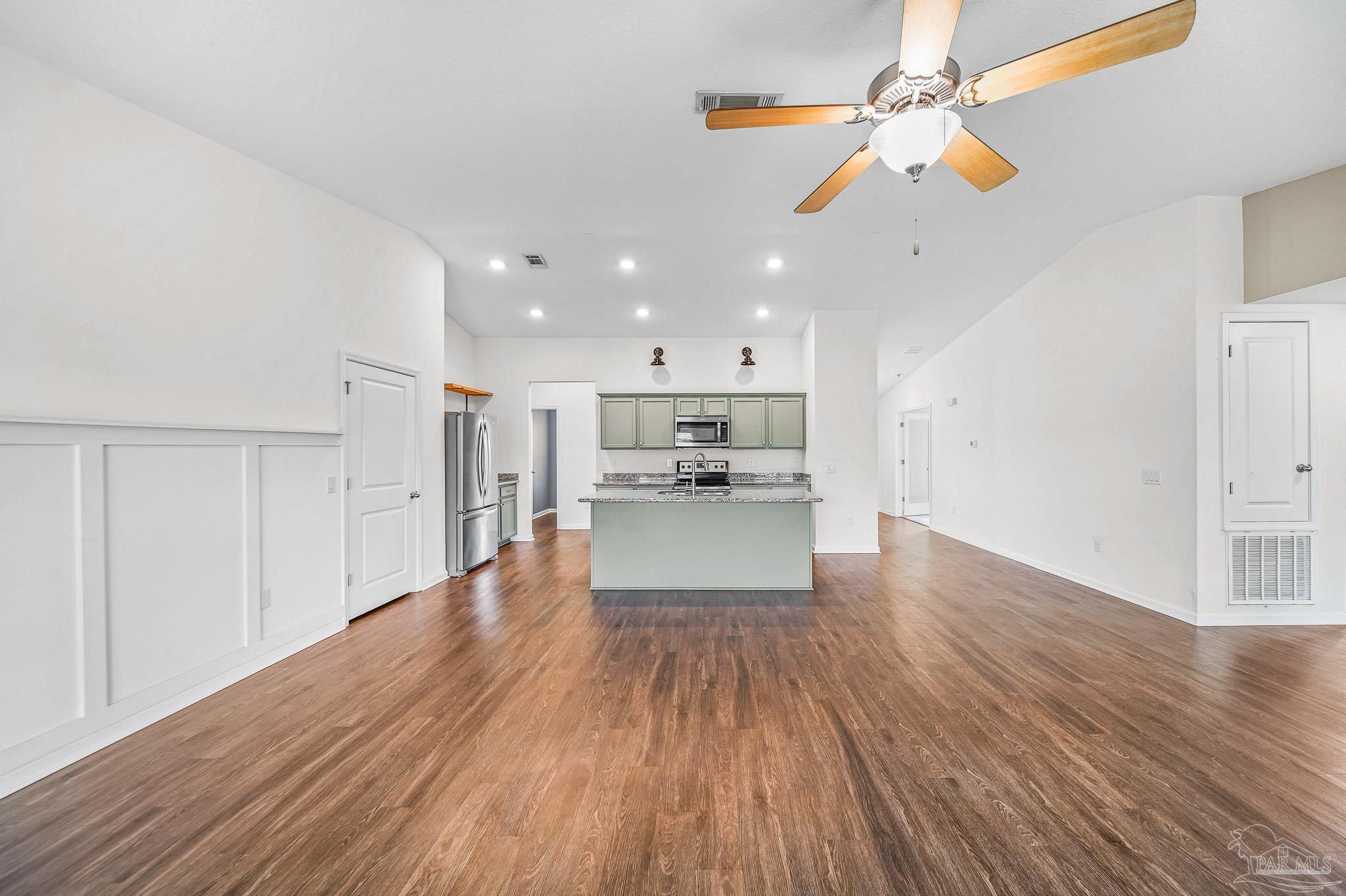 4706 Determination Court Milton, FL 32570 - Photo 12 of 34 a view of kitchen with wooden floor and window