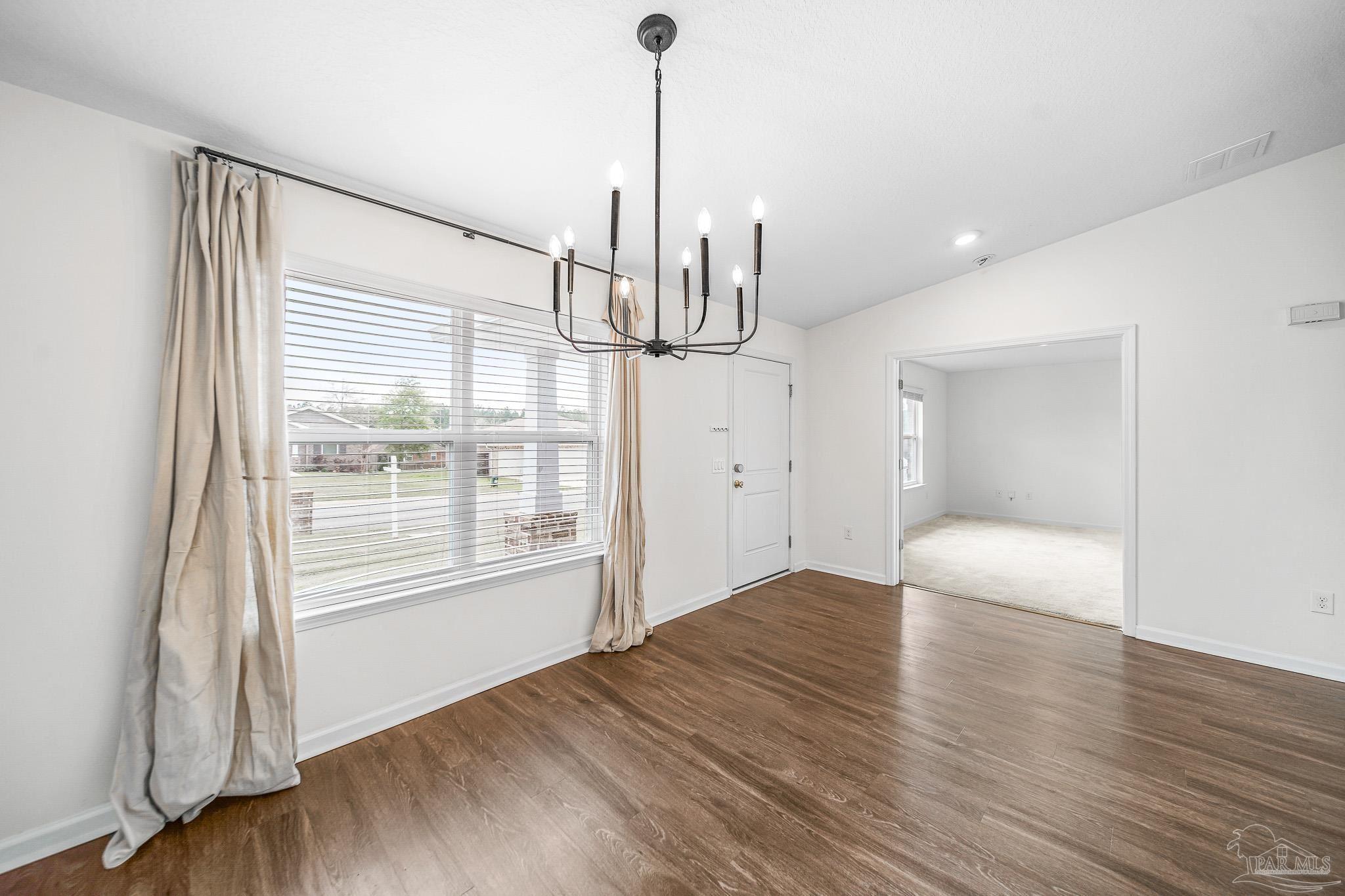 4706 Determination Court Milton, FL 32570 - Photo 16 of 34 a view of empty room with wooden floor and fan