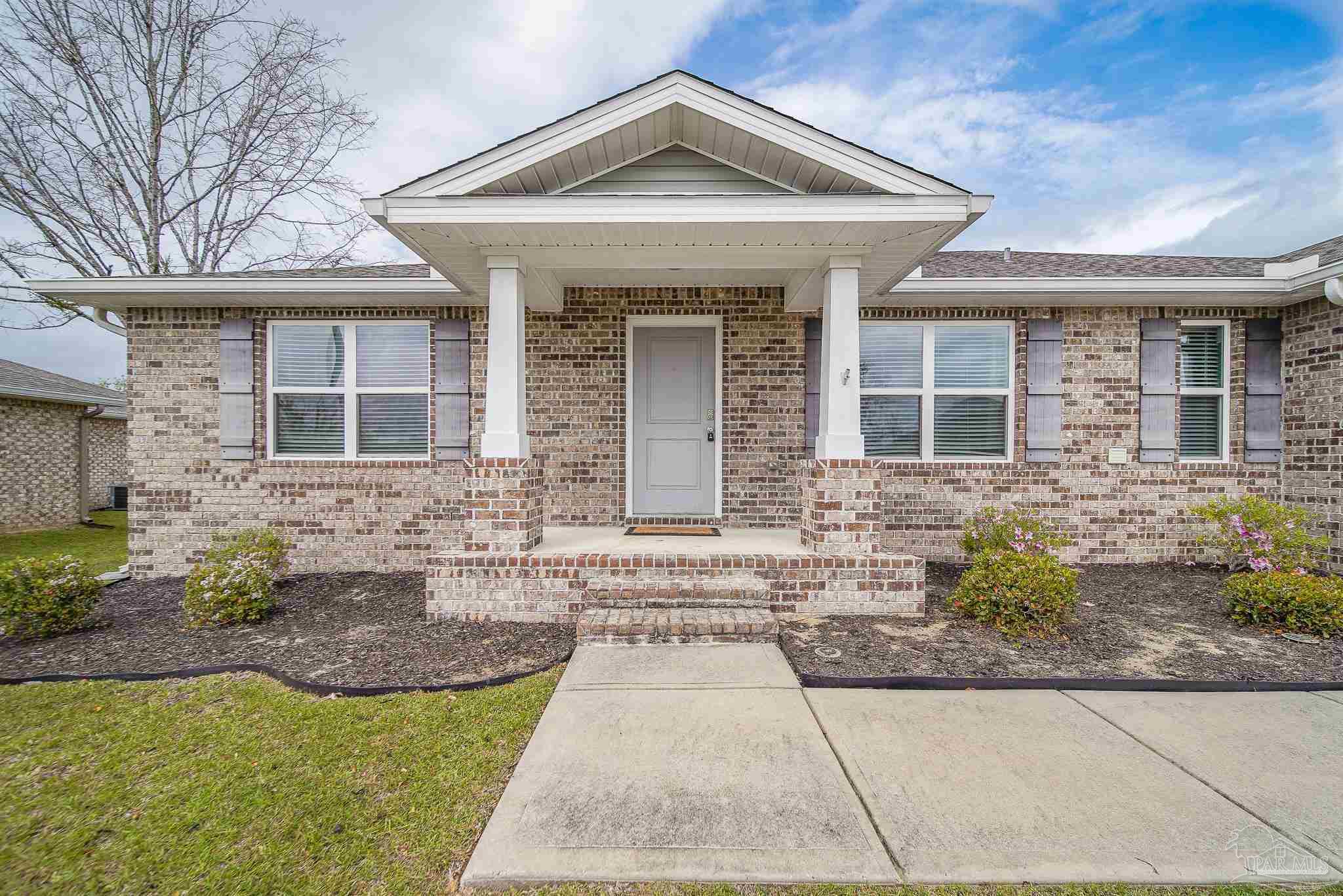 4706 Determination Court Milton, FL 32570 - Photo 2 of 34 a front view of a house with garden