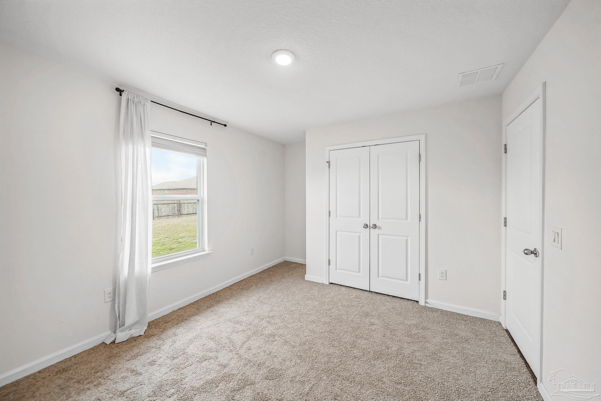 4706 Determination Court Milton, FL 32570 - Photo 22 of 34 a view of an empty room with a window