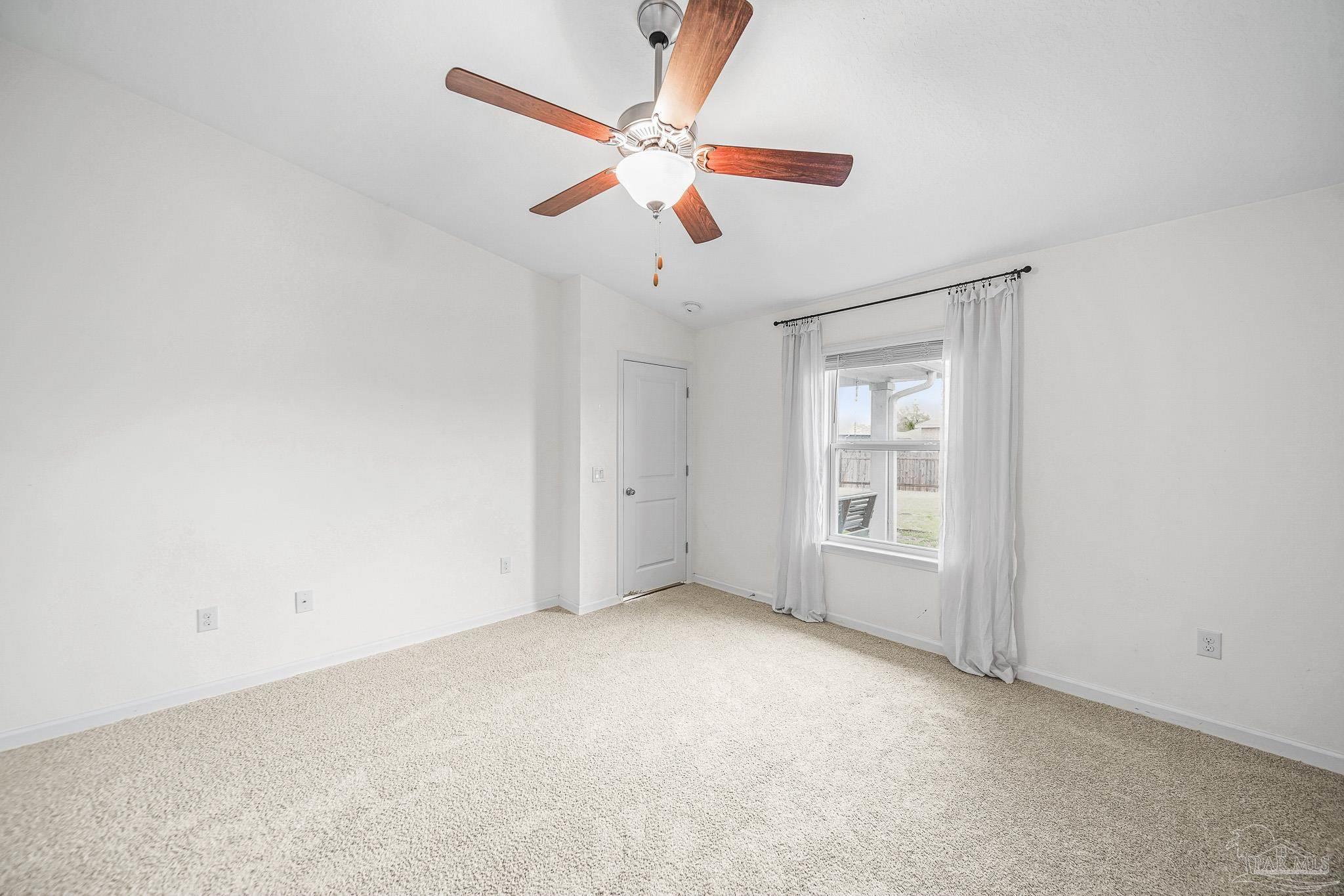 4706 Determination Court Milton, FL 32570 - Photo 25 of 34 an empty room with windows and fan