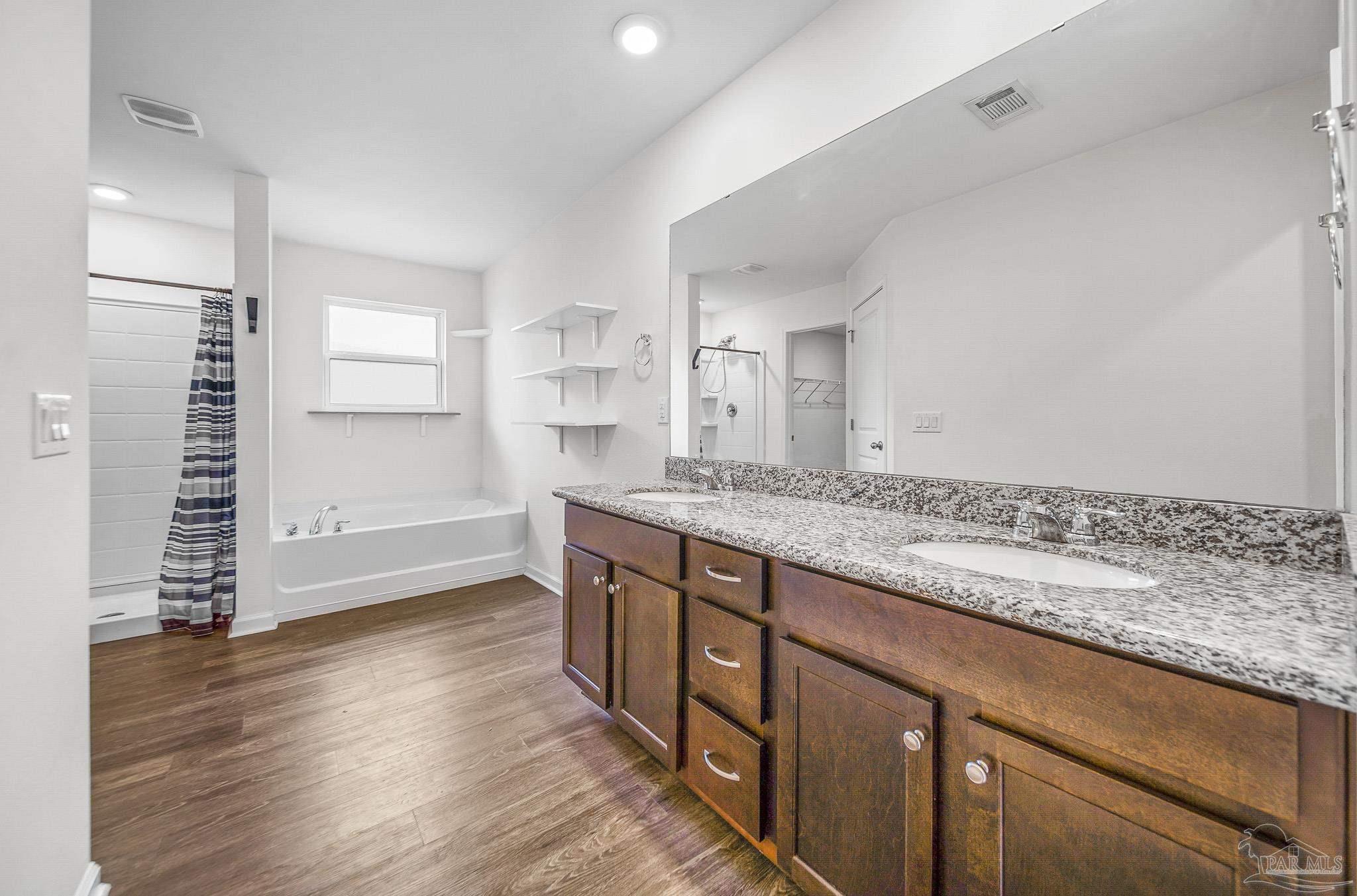 4706 Determination Court Milton, FL 32570 - Photo 27 of 34 a bathroom with a granite countertop sink and a mirror