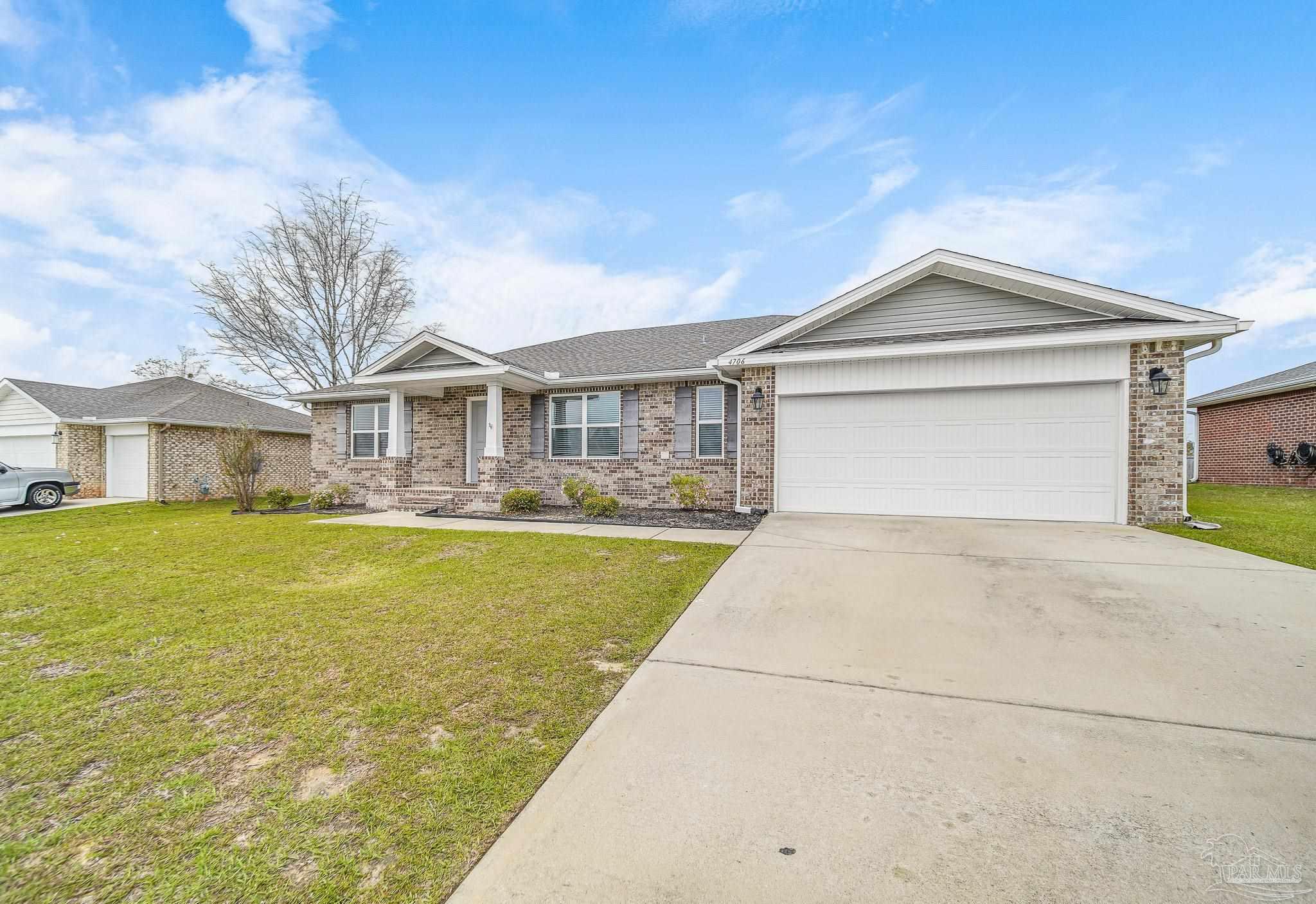 4706 Determination Court Milton, FL 32570 - Photo 3 of 34 a front view of a house with a yard and lake view