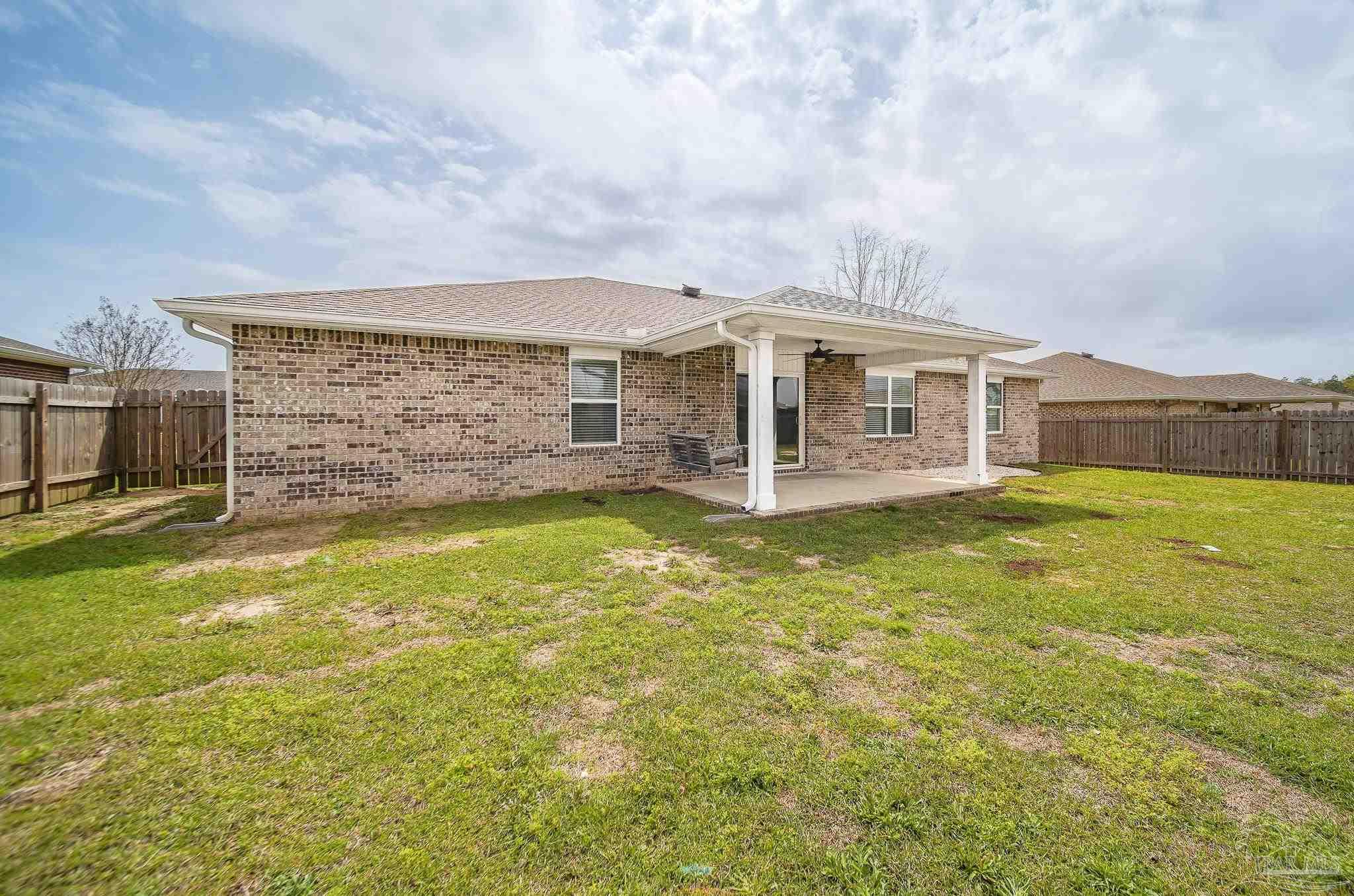 4706 Determination Court Milton, FL 32570 - Photo 34 of 34 a view of a house with a swimming pool and a yard