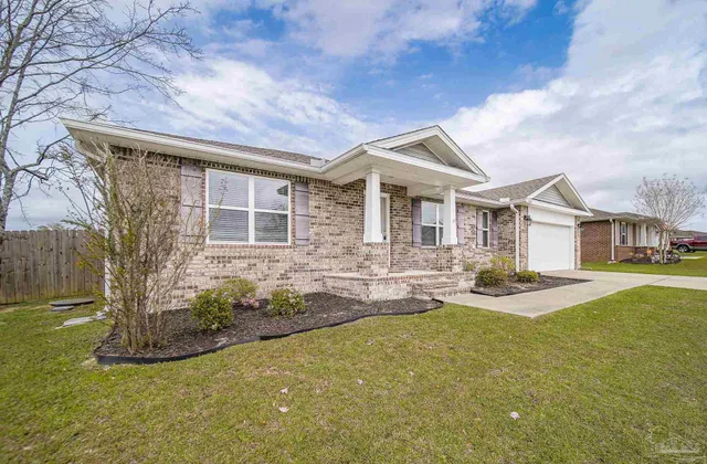 a front view of a house with yard and porch