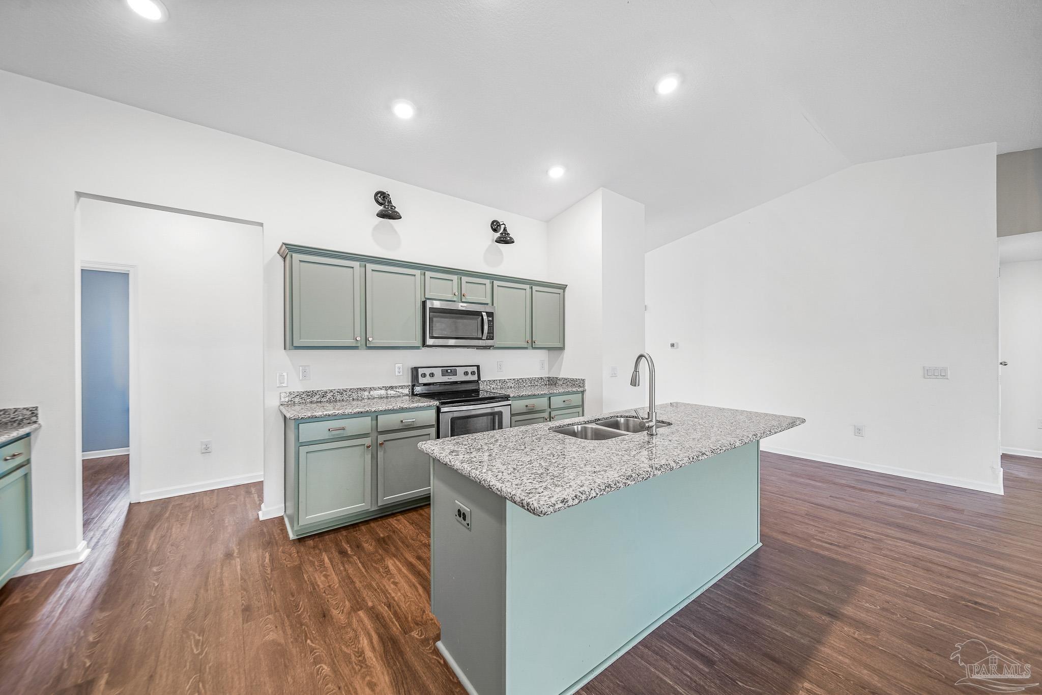 4706 Determination Court Milton, FL 32570 - Photo 6 of 34 a open kitchen with stainless steel appliances granite countertop a sink dishwasher stove and refrigerator with wooden floor