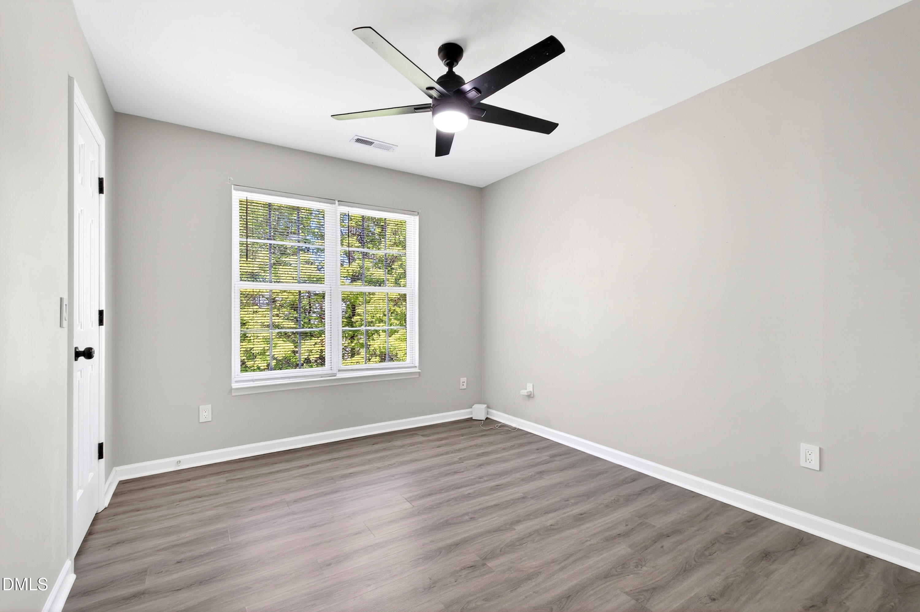 37 Red Lane Raleigh, NC 27606 - Photo 15 of 32 an empty room with wooden floor and windows