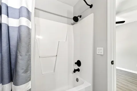 a bathroom with a shower and a tub
