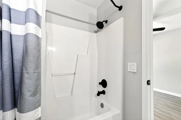 a bathroom with a shower and a tub