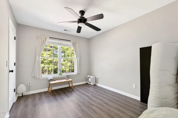 a view of room with a ceiling fan and a window