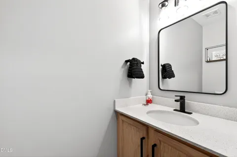 a bathroom with a sink and mirror