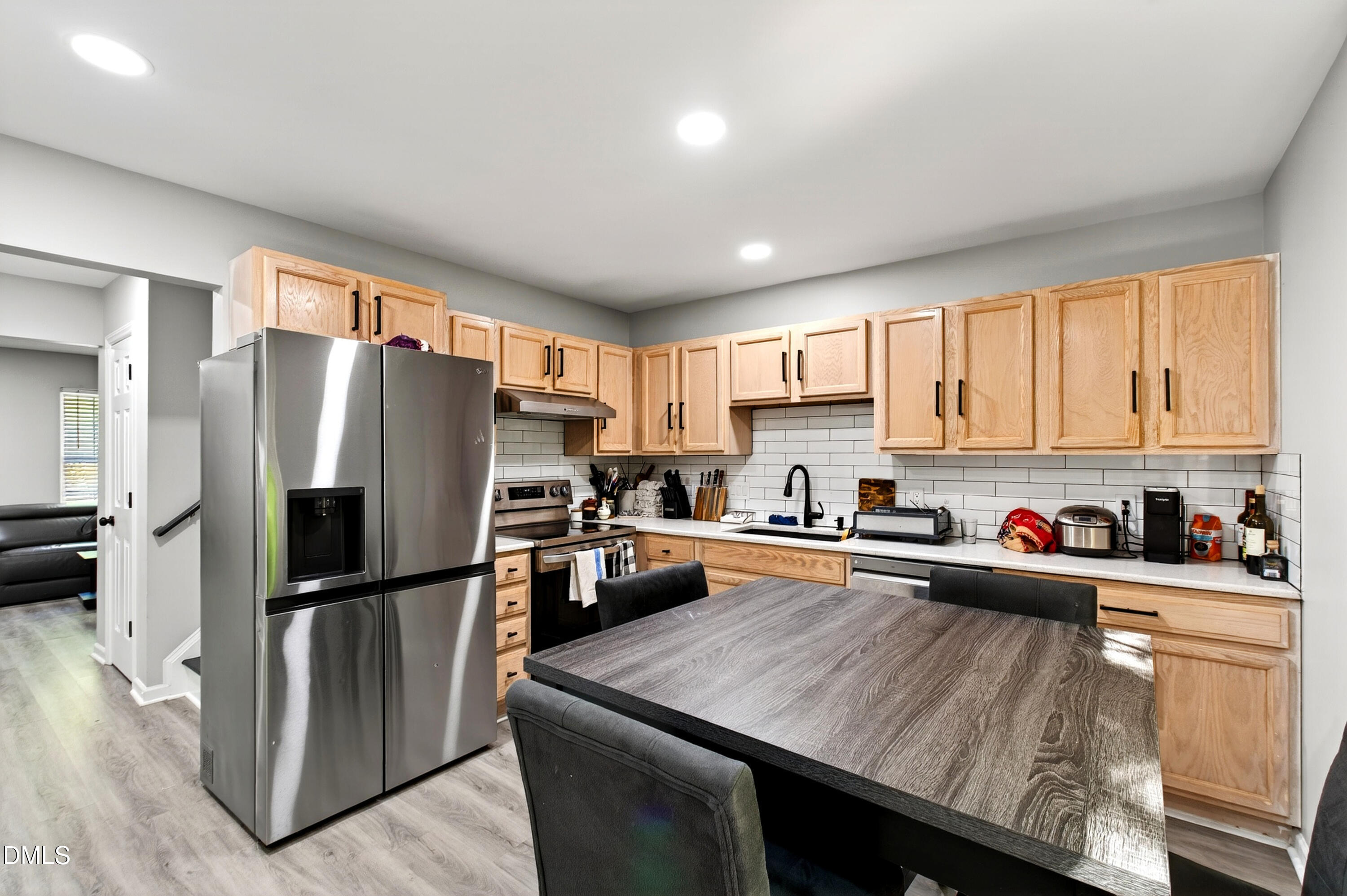 37 Red Lane Raleigh, NC 27606 - Photo 6 of 32 a kitchen with stainless steel appliances a refrigerator sink stove microwave and cabinets