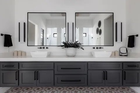 a bathroom with a double vanity sink and a mirror