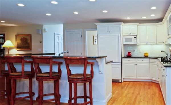 87 Winslow Road Newton, MA 02468 - Photo 3 of 9 a kitchen with stainless steel appliances granite countertop a table chairs sink and cabinets