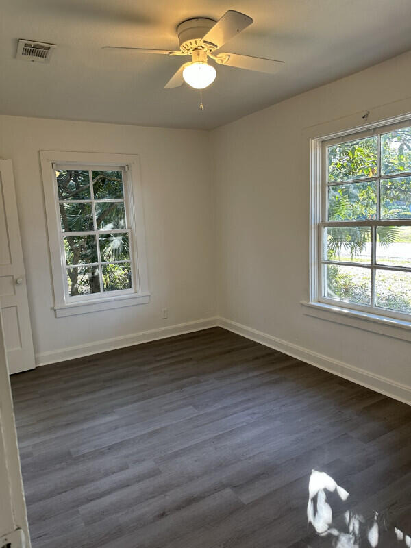 324 Dixie Street Crestview, FL 32536 - Photo 4 of 8 a view of an empty room with wooden floor and a window
