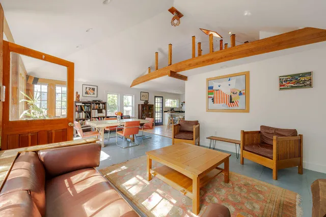 a living room with furniture a rug and a large window