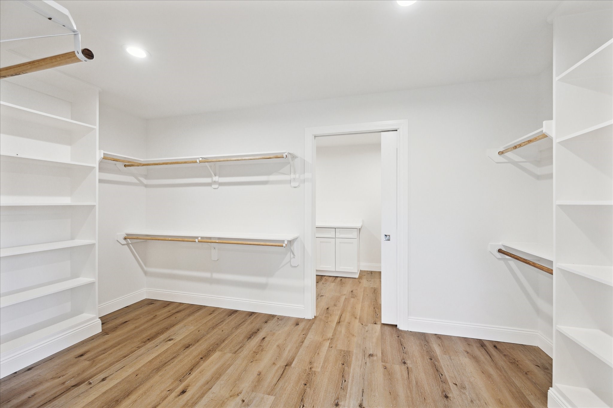 1935 Willow Road Wallis, TX 77485 - Photo 19 of 34 Spacious walk-in primary closet with ample shelving and hanging space that connects to utility room.