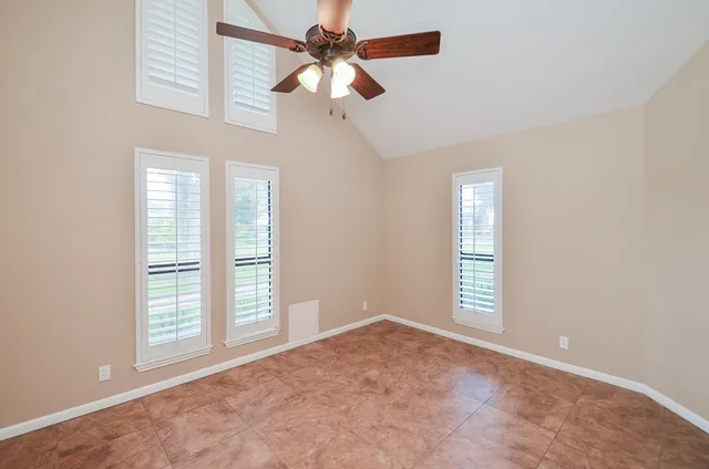 an empty room with windows and closet