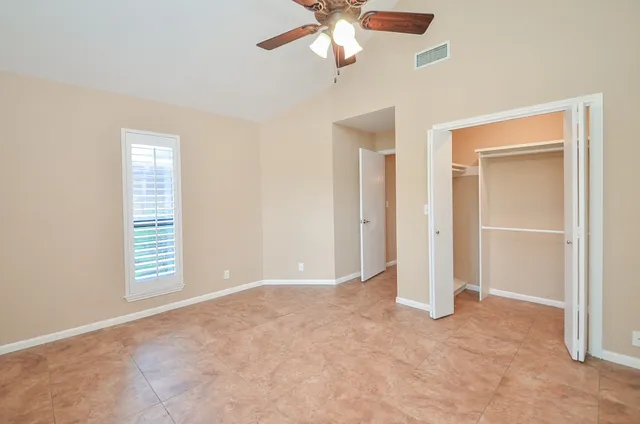 a utility room with granite countertop cabinets washer and dryer