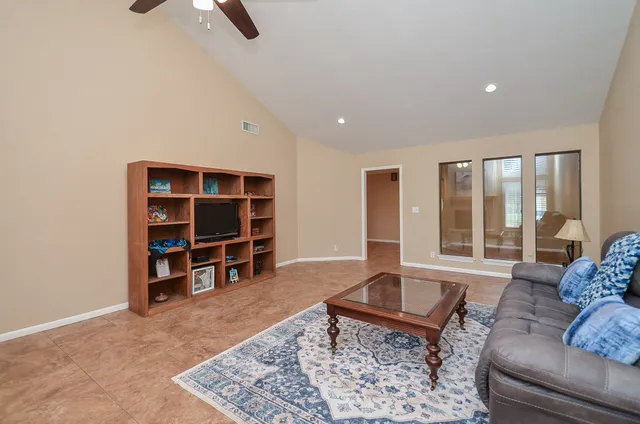 a living room with furniture a fireplace and a chandelier