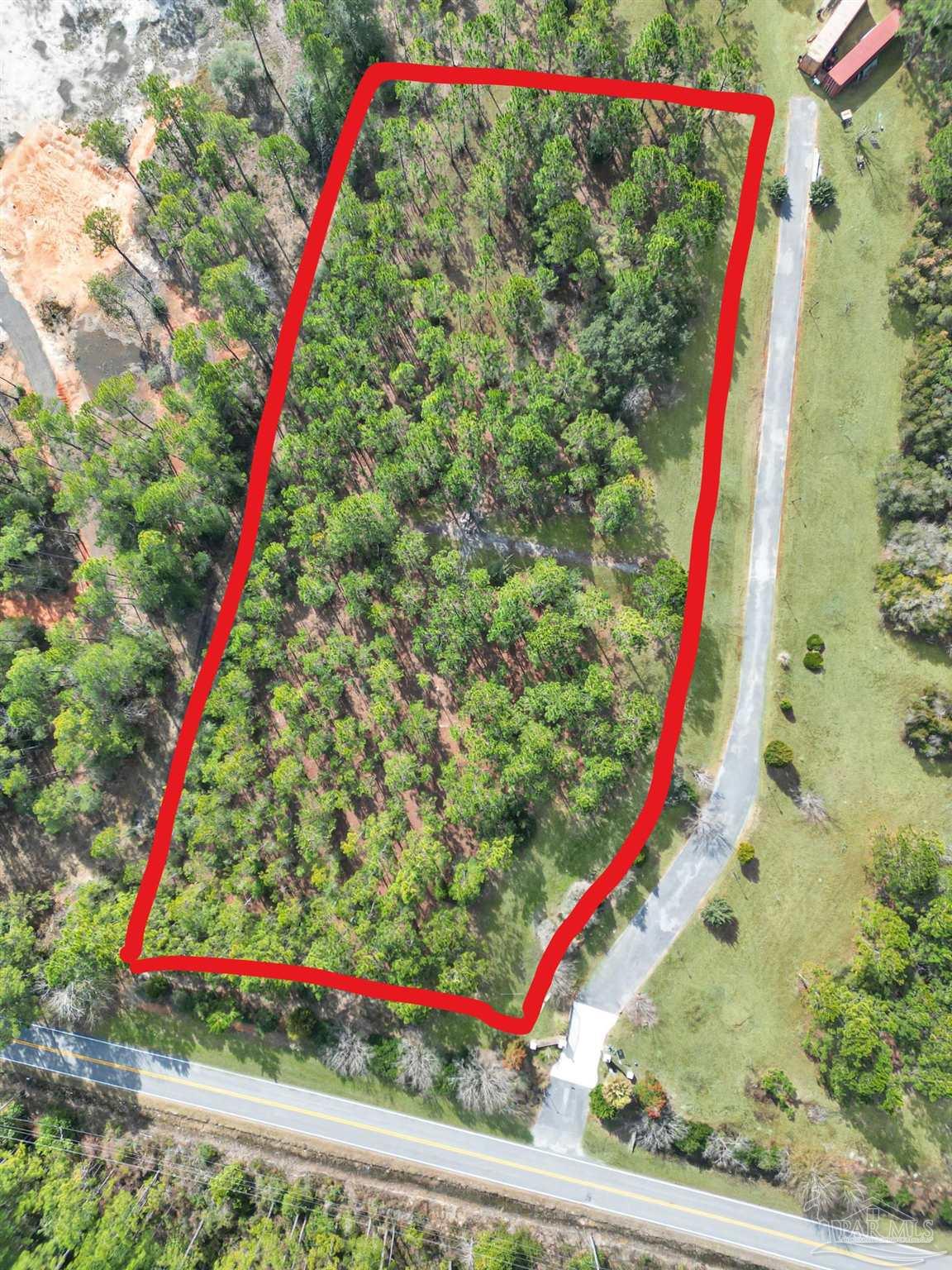 0 Mary Kitchens Road Milton, FL 32583 - Photo 14 of 14 a view of a yard with a wooden deck and a tree