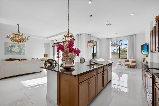 a living room with furniture chandelier and fireplace