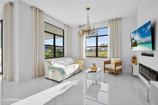 a living room with a couch and chandelier